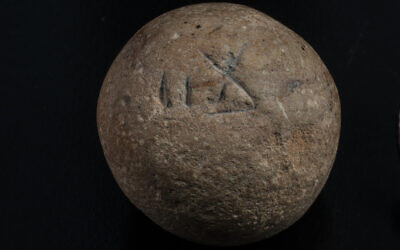 The 2,700-year-old limestone two shekel weight. (Shai Halevi, Israel Antiquities Authority)