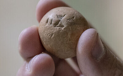 The 2,700-year-old limestone two shekel weight. (Shai Halevi, Israel Antiquities Authority)