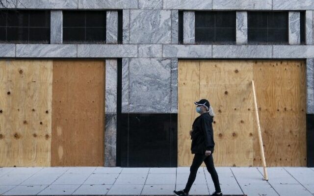 Wooden boards protect a Starbucks location near the White House on October 31, 2020, in Washington, DC. (Alex Edelman / AFP) Wooden boards protect a Starbucks location near the White House on October 31, 2020, in Washington, DC. (Alex Edelman / AFP)