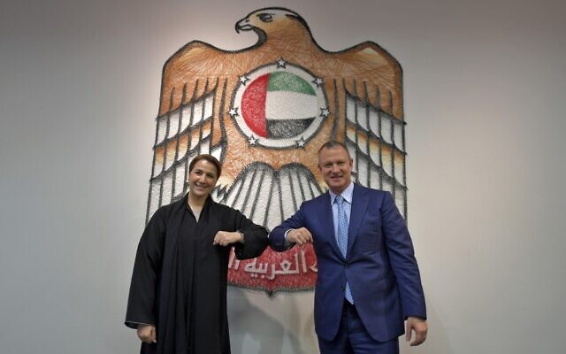 In this photo taken on October 27, 2020, Emirati Minister of State for Food and Water Security Mariam al-Muhairi (L) and Erel Margalit, founder and chairman of Jerusalem Venture Partners (JVP), greet each other with an elbow bump at the headquarters of the Government Accelerators in Dubai. (Karim SAHIB / AFP) In this photo taken on October 27, 2020, Emirati Minister of State for Food and Water Security Mariam al-Muhairi (L) and Erel Margalit, founder and chairman of Jerusalem Venture Partners (JVP), greet each other with an elbow bump at the headquarters of the Government Accelerators in Dubai. (Karim SAHIB / AFP)