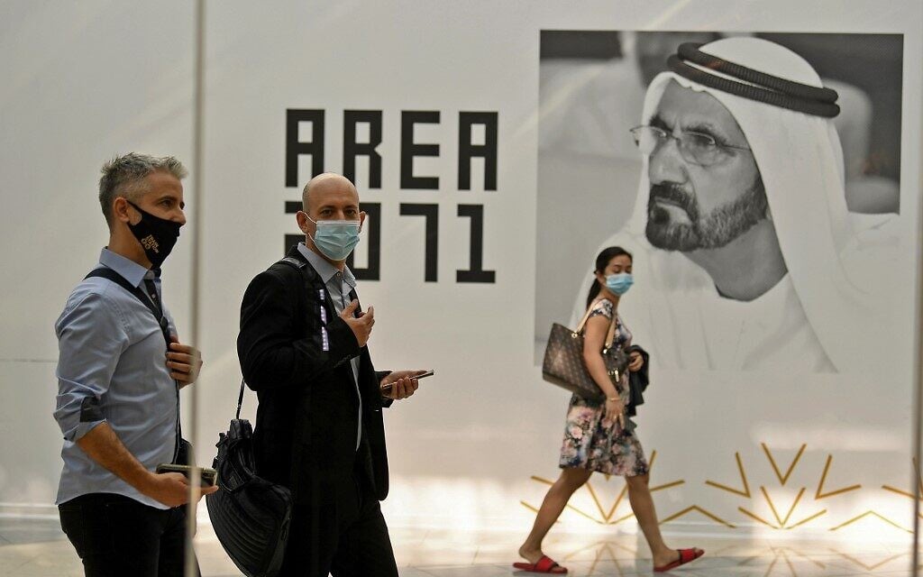 Members of an Israeli high-tech delegation walk past a poster of Dubai's ruler Sheikh Mohammed bin Rashid al-Maktoum during a meeting with Emirati counterparts at the headquarters of the Government Accelerators in Dubai, on October 27, 2020. (Karim Sahib/AFP)