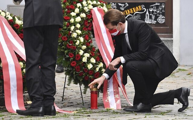 Austrian Chancellor Sebastian Kurz places a candle at a crime scene as he pays his respects to the victims of a shooting in Vienna on November 3, 2020 (JOE KLAMAR / AFP)