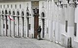 An armed policeman stands guard in front of the synagogue in Seitenstettengasse in Vienna on November 3, 2020, one day after the shootings nearby and at multiple locations across central Vienna. (Hans Punz/APA/AFP)
