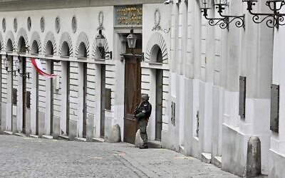 An armed policeman stands guard in front of the synagogue in Seitenstettengasse in Vienna on November 3, 2020, one day after the shootings nearby and at multiple locations across central Vienna. (Hans Punz/APA/AFP)
