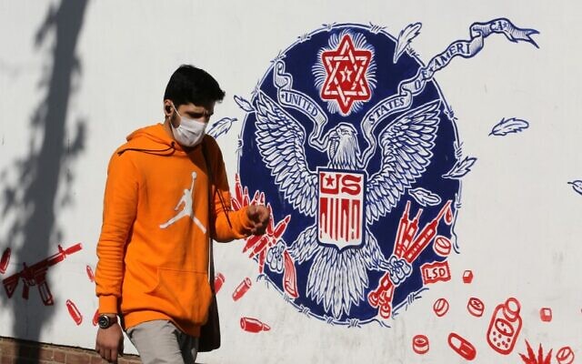 An Iranian man walks past a mural painted on the outer walls of the former US embassy in the Iranian capital Tehran, on November 4, 2020 as the US waits for the results of the presidential election. (ATTA KENARE / AFP) An Iranian man walks past a mural painted on the outer walls of the former US embassy in the Iranian capital Tehran, on November 4, 2020 as the US waits for the results of the presidential election. (ATTA KENARE / AFP)