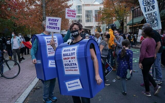 People dressed as mailboxes dance outside the Pennsylvania Convention Center, as ballot counting continues inside, in Philadelphia, Pennsylvania, on November 6, 2020. (Bryan R. Smith/AFP) People dressed as mailboxes dance outside the Pennsylvania Convention Center, as ballot counting continues inside, in Philadelphia, Pennsylvania, on November 6, 2020. (Bryan R. Smith/AFP)