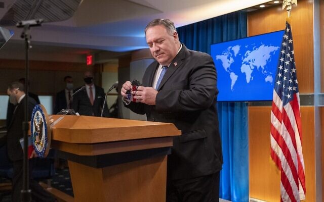 US Secretary of State Mike Pompeo removes his facemask as he arrives for a media briefing on November 10, 2020, at the State Department in Washington, DC. (Jacquelyn Martin / POOL / AFP) US Secretary of State Mike Pompeo removes his facemask as he arrives for a media briefing on November 10, 2020, at the State Department in Washington, DC. (Jacquelyn Martin / POOL / AFP)
