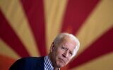 In this file photo taken on October 8, 2020 Democratic presidential candidate former US Vice President Joe Biden pauses while speaking to supporters in front of an Arizona state flag, at the United Brotherhood of Carpenters and Joiners of America's training center in Phoenix, Arizona. (Brendan Smialowski / AFP)