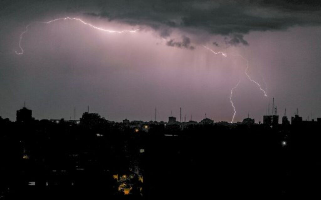 Lightning above buildings during a thunderstorm in Gaza City, on November 15, 2020. (Mahmud Hams / AFP) Lightning above buildings during a thunderstorm in Gaza City, on November 15, 2020. (Mahmud Hams / AFP)