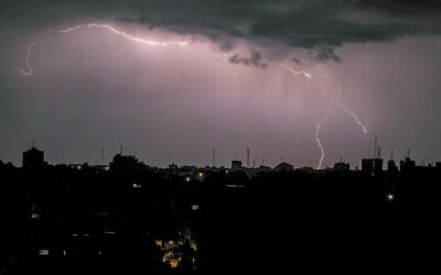Lightning above buildings during a thunderstorm in Gaza City, on November 15, 2020. (Mahmud Hams / AFP)