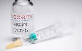 A syringe and a vial with the logo of US biotech firm Moderna. (AFP)