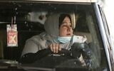 The first female Palestinian taxi driver in the Gaza Strip, Nayla Abu Jubbah, sits at her vehicle as she works in Gaza City on November 17, 2020. (Mahmud Hams/AFP)