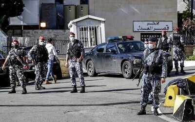 Policemen stand guard outside a detention center from which prisoners had fled earlier in Baabda, east of Lebanon's capital Beirut, on November 21, 2020. (Anwar Amro/AFP)
