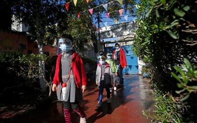 Palestinian children attend a kindergarten while wearing face shields due to the COVID-19 pandemic, in Gaza City, on November 23, 2020. (Mohammed ABED / AFP)