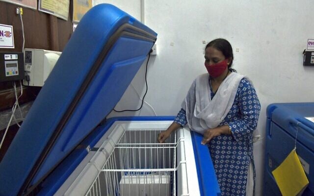 A pharmacy officer conducts routine checks of the Electronic Vaccine Intelligence Network (EVIN) cold storage equipment, at a government hospital proposed by the Bangalore municipality for the storage and dispatch of the COVID-19 vaccine when available, in Bangalore on November 23, 2020. (Manjunath Kiran/AFP) A pharmacy officer conducts routine checks of the Electronic Vaccine Intelligence Network (EVIN) cold storage equipment, at a government hospital proposed by the Bangalore municipality for the storage and dispatch of the COVID-19 vaccine when available, in Bangalore on November 23, 2020. (Manjunath Kiran/AFP)