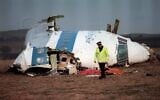 A policeman walking away from the damaged cockpit of the 747 Pan Am airliner that exploded and crashed over Lockerbie, Scotland, with 259 people on board, December 22, 1988. (ROY LETKEY/AFP)