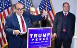 Trump lawyer Rudy Giuliani speaks at a press conference watched by Trump campaign adviser Boris Epshteyn, right, at the Republican National Committee headquarters in Washington, DC, November 19, 2020. (Mandel Ngan/AFP)