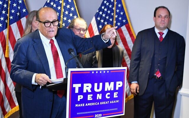 Trump lawyer Rudy Giuliani speaks at a press conference watched by Trump campaign adviser Boris Epshteyn, right, at the Republican National Committee headquarters in Washington, DC, November 19, 2020. (Mandel Ngan/AFP) Trump lawyer Rudy Giuliani speaks at a press conference watched by Trump campaign adviser Boris Epshteyn, right, at the Republican National Committee headquarters in Washington, DC, November 19, 2020. (Mandel Ngan/AFP)