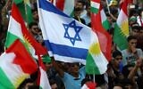 Iraqi Kurds wave an Israeli flag and Kurdish flags during an event urging people to vote in an independence referendum in Arbil, the capital of the autonomous Kurdish region of northern Iraq, September 16, 2017. (Safin Hamed/AFP)