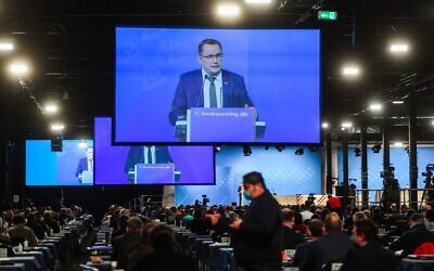 Tino Chrupalla, Federal Spokesperson, is seen on video screens during his speech at the Party Congress of farright AfD party at the Wunderland Kalkar, western Germany, on November 28, 2020. (INA FASSBENDER / AFP)