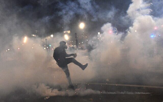 A demonstrator reacts during clashes with French riot police during a demonstration against the 'global security' draft law' in Paris, on November 28, 2020. (Alain JOCARD / AFP) A demonstrator reacts during clashes with French riot police during a demonstration against the 'global security' draft law' in Paris, on November 28, 2020. (Alain JOCARD / AFP)