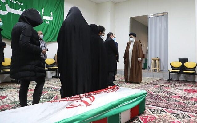 Iran's Judiciary Chief Ayatollah Ebrahim Raisi (R) pays respects to the body of slain scientist Mohsen Fakhrizadeh among his family, in the capital Tehran on November 28, 2020. (MIZAN NEWS AGENCY / AFP) Iran's Judiciary Chief Ayatollah Ebrahim Raisi (R) pays respects to the body of slain scientist Mohsen Fakhrizadeh among his family, in the capital Tehran on November 28, 2020. (MIZAN NEWS AGENCY / AFP)