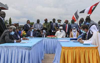 The head of Sudan's sovereign council, Gen. Abdel-Fattah Burhan, seated center-left, President of South Sudan Salva Kiir, seated center, and President of Chad Idriss Deby, seated center-right, attend a ceremony to sign a peace deal between Sudan's transitional authorities and a rebel alliance, in Juba, South Sudan, Saturday, Oct. 3, 2020. Sudan's transitional authorities and a rebel alliance on Saturday signed the peace deal initialed in August that aims to put an end to the country's decades-long civil wars, in a televised ceremony in Juba, South Sudan marking the agreement. (AP Photo/Maura Ajak)