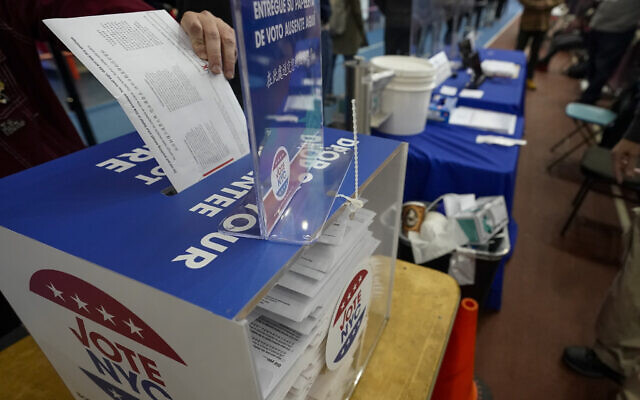 A voter drops an absentee ballot in a locked ballot box during early voting at the Park Slope Armory YMCA in Brooklyn, New York, October 27, 2020. (Mary Altaffer/AP) A voter drops an absentee ballot in a locked ballot box during early voting at the Park Slope Armory YMCA in Brooklyn, New York, October 27, 2020. (Mary Altaffer/AP)