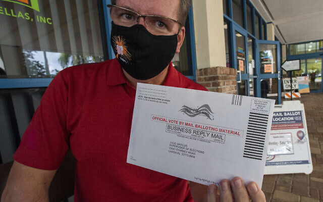 Charles Oppermann holds his vote by mail ballot for Joe Biden outside the drop-off location at the Dunedin Public Library, October 29, 2020. (AP Photo/Steve Nesius) Charles Oppermann holds his vote by mail ballot for Joe Biden outside the drop-off location at the Dunedin Public Library, October 29, 2020. (AP Photo/Steve Nesius)