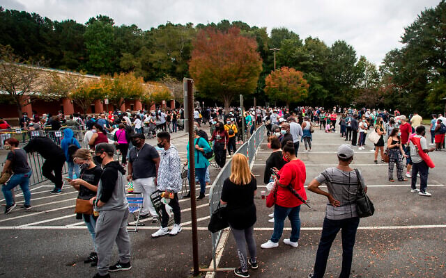 Hundreds of people wait in line for early voting on October 12, 2020, in Marietta, Georgia. (AP Photo/Ron Harris) Hundreds of people wait in line for early voting on October 12, 2020, in Marietta, Georgia. (AP Photo/Ron Harris)