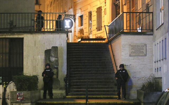 Police officers stay in position at stairs named 'Theodor Herzl Stiege' near a synagogue after gunshots were heard, in Vienna, November 2, 2020. (Ronald Zak/AP)