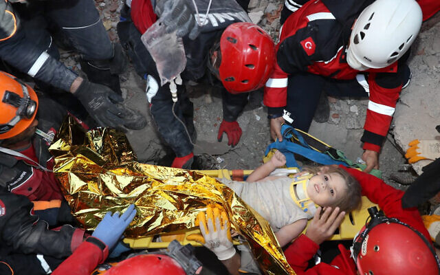 Rescue workers, who were trying to find survivors of an earthquake, surround Ayda Gezgin after they pulled the young girl out alive from the rubble of a collapsed apartment in the Turkish coastal city of Izmir, November 3, 2020, (AFAD via AP) Rescue workers, who were trying to find survivors of an earthquake, surround Ayda Gezgin after they pulled the young girl out alive from the rubble of a collapsed apartment in the Turkish coastal city of Izmir, November 3, 2020, (AFAD via AP)