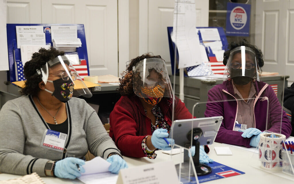 Election workers prepare to register voters on Election Day at a polling place inside the Bartow Community Center, November 3, 2020, in the Bronx borough of New York. (AP Photo/Mark Lennihan)