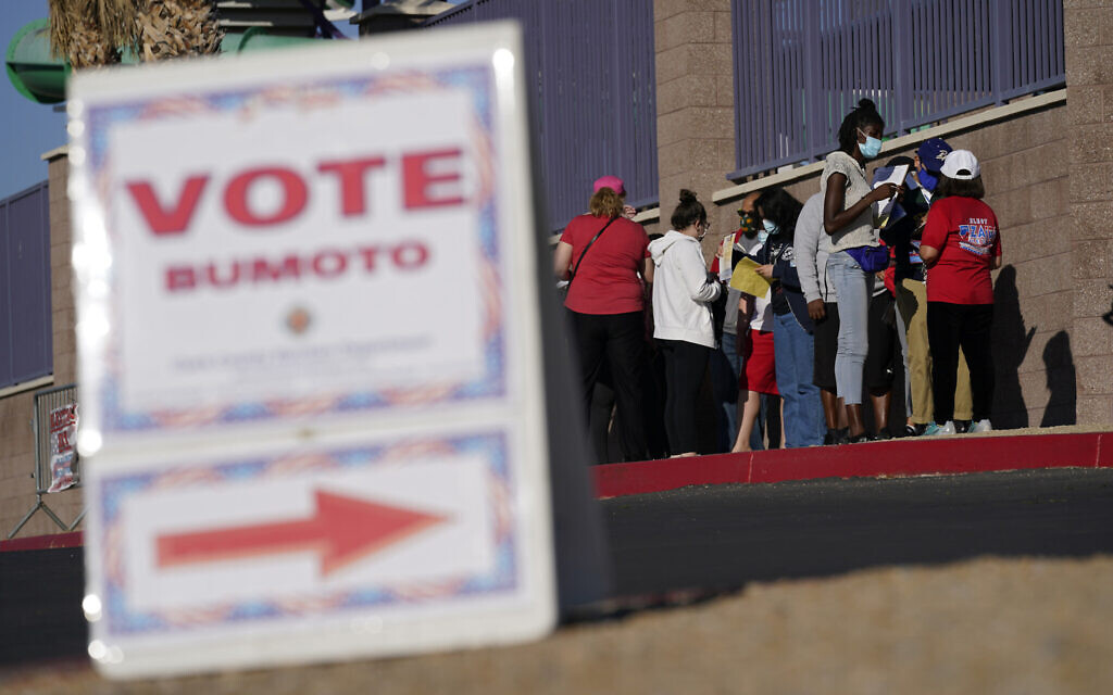 People wait in line to vote at a polling place on Election Day, November 3, 2020, in Las Vegas. (AP Photo/John Locher)