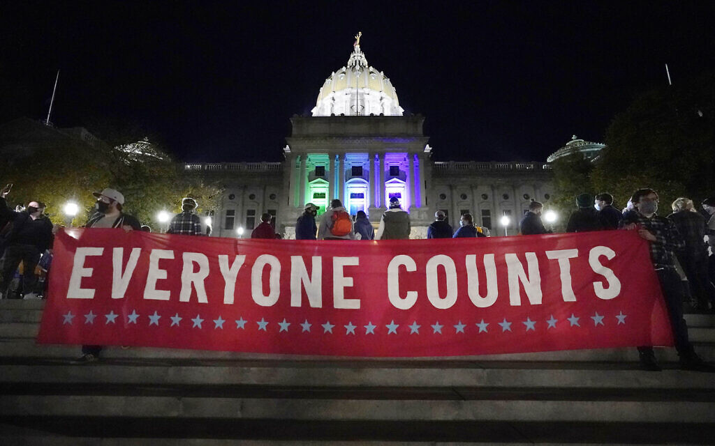 People demonstrate outside the Pennsylvania State Capitol to urge that all votes be counted on November 4, 2020, in Harrisburg, Pennsylvania. (AP Photo/Julio Cortez)