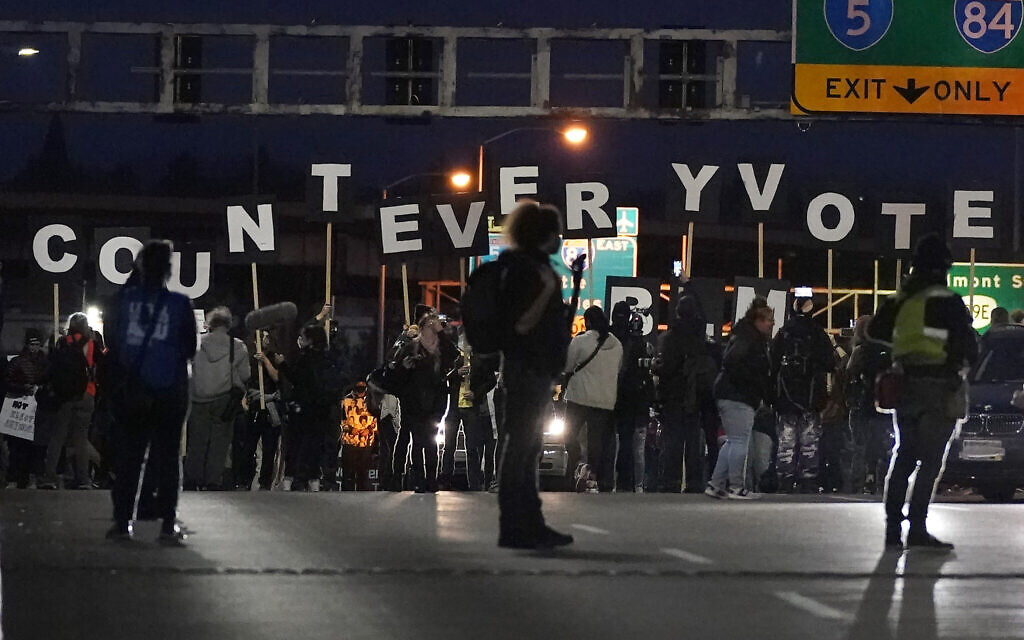 Protesters hold letters that spell Count Every Vote as they cross an overpass while marching in Portland, Oregon, November 4, 2020, following the US election. (AP Photo/Marcio Jose Sanchez)