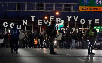 Protesters hold letters that spell Count Every Vote as they cross an overpass while marching in Portland, Oregon, November 4, 2020. (AP Photo/Marcio Jose Sanchez)