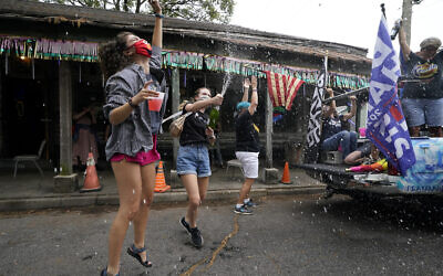 People celebrate outside Vaughn's Lounge in the Bywater section of New Orleans, Saturday, Nov. 7, 2020, after news outlets called the Presidential election in favor of President-elect Joe Biden and his running mate, Vice President-elect Kamala Harris. (AP Photo/Gerald Herbert)