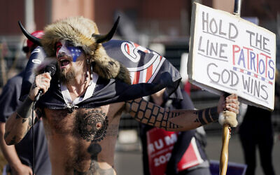 Jake Angeli, a supporter of President Donald Trump, speaks at a rally outside the Maricopa County Recorder's Office Saturday, Nov. 7, 2020, in Phoenix (AP Photo/Ross D. Franklin)