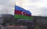 Azerbaijan's national flag with the city of Shushi in the background, in the separatist region of Nagorno-Karabakh, November 9, 2020. (Azerbaijan's Defense Ministry via AP)