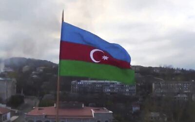 Azerbaijan's national flag with the city of Shushi in the background, in the separatist region of Nagorno-Karabakh, November 9, 2020. (Azerbaijan's Defense Ministry via AP)