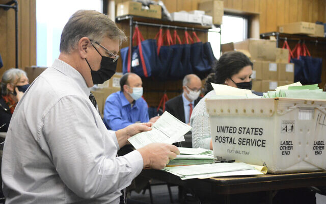 Election Bureau Director Albert L. Gricoski, left, opens provisional ballots alongside election bureau staff Christine Marmas, right, while poll watchers observe from behind at the Schuylkill County Election Bureau in Pottsville, Pa. on Tuesday, Nov. 10, 2020. (Lindsey Shuey/The Republican-Herald via AP) Election Bureau Director Albert L. Gricoski, left, opens provisional ballots alongside election bureau staff Christine Marmas, right, while poll watchers observe from behind at the Schuylkill County Election Bureau in Pottsville, Pa. on Tuesday, Nov. 10, 2020. (Lindsey Shuey/The Republican-Herald via AP)