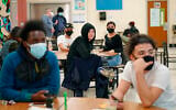 Students at West Brooklyn Community High School listen to questions posed by their principal during a current events-trivia quiz and pizza party in the school's cafeteria, in New York on October 29, 2020. (AP/Kathy Willen, File)