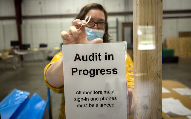 A Chatham County election official posts a sign in the public viewing area before the start of a ballot audit on November 13, 2020, in Savannah, Georgia. (AP/Stephen B. Morton) A Chatham County election official posts a sign in the public viewing area before the start of a ballot audit on November 13, 2020, in Savannah, Georgia. (AP/Stephen B. Morton)