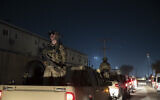 Armed US soldiers stand guard in the motorcade for President Donald Trump as he makes a surprise Thanksgiving Day visit to the troops at Bagram Air Field, Afghanistan. (AP Photo/Alex Brandon, File)