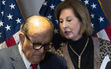 Former mayor of New York Rudy Giuliani, left, listens to Sidney Powell, both lawyers for US President Donald Trump, during a news conference at the Republican National Committee headquarters, November 19, 2020, in Washington. (AP Photo/Jacquelyn Martin)
