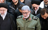 In this photo released by the official website of the Office of the Iranian Supreme Leader, Gen. Esmail Ghaani, newly appointed commander of Iran's Revolutionary Guards Quds Force, weeps while praying over the coffin of the force's previous head Gen. Qassem Soleimani at the Tehran University Campus in Tehran, Iran on January 6, 2020.  (Office of the Iranian Supreme Leader via AP)