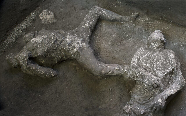 The casts of what are believed to have been a rich man and his male slave fleeing the volcanic eruption of Vesuvius nearly 2,000 years ago, are seen in what was an elegant villa on the outskirts of the ancient Roman city of Pompeii destroyed by the eruption in 79 A.D., where they were discovered during recents excavations, Pompeii archaeological park officials said Saturday, Nov. 21, 2020. (Parco Archeologico di Pompei via AP)