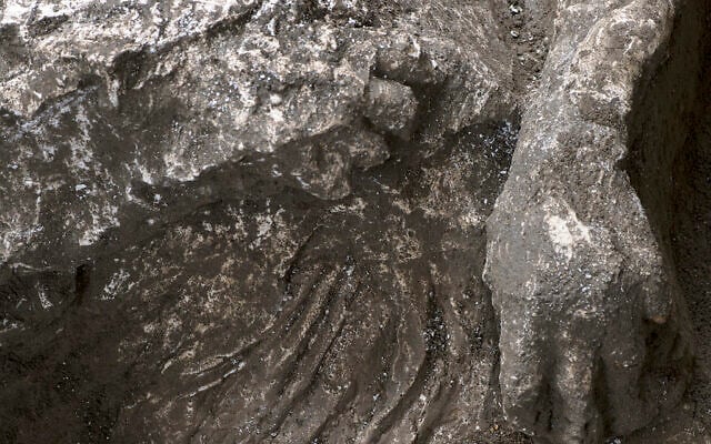 A detail of the casts of one of two bodies that are believed to have been a rich man and his male slave fleeing the volcanic eruption of Vesuvius nearly 2,000 years ago, are seen in what was an elegant villa on the outskirts of the ancient Roman city of Pompeii destroyed by the eruption in 79 A.D., where they were discovered during recents excavations, Pompeii archaeological park officials said Saturday, Nov. 21, 2020. (Parco Archeologico di Pompei via AP)