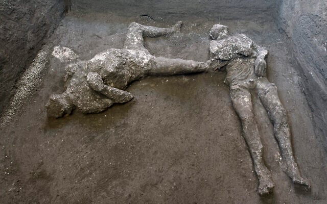 The casts of what are believed to have been a rich man and his male slave fleeing the volcanic eruption of Vesuvius nearly 2,000 years ago, are seen in what was an elegant villa on the outskirts of the ancient Roman city of Pompeii. (Parco Archeologico di Pompei via AP)